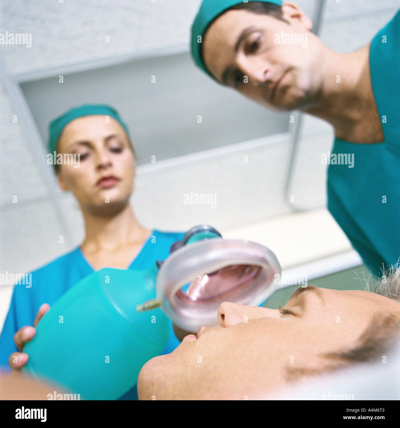 Doctors placing oxygen mask over patient's face Stock Photo