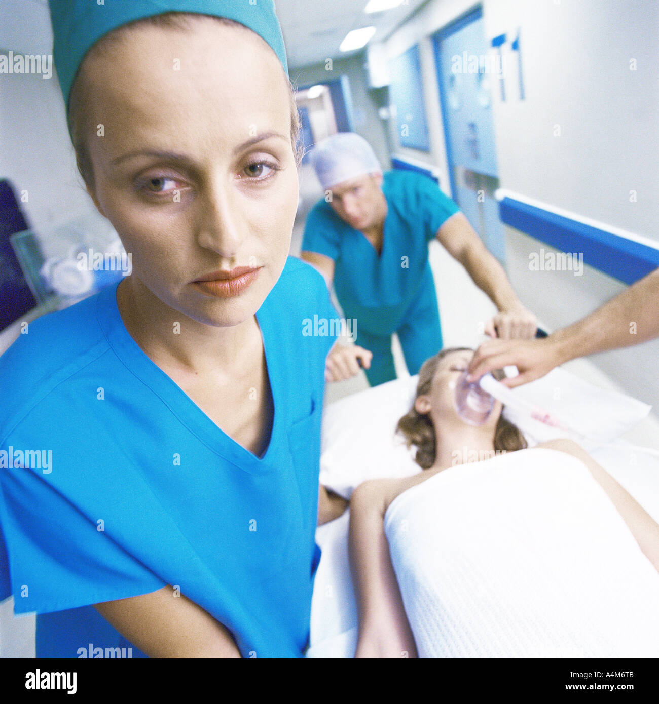 Medical team moving patient on gurney Stock Photo Alamy