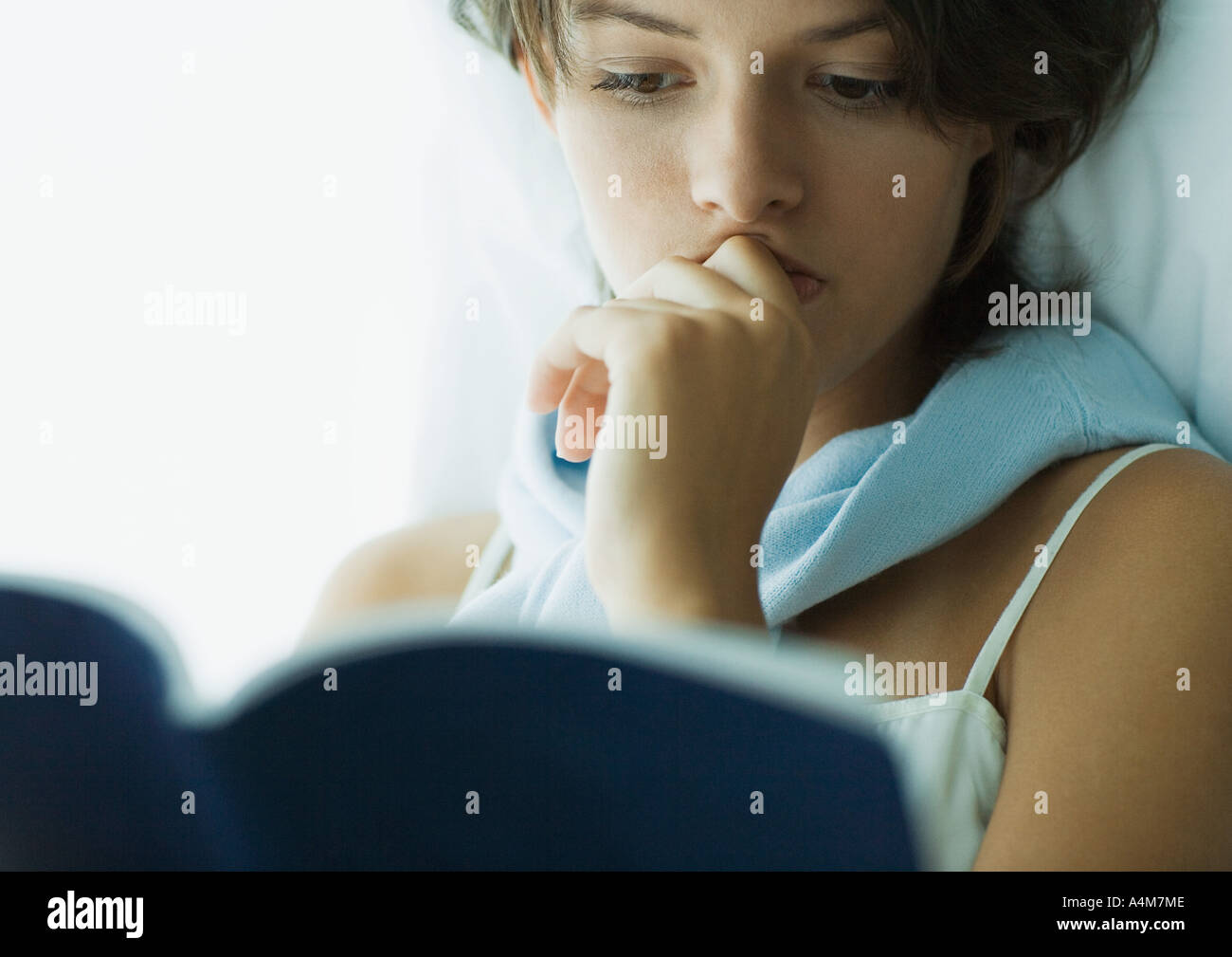 Young woman reading book, close-up Stock Photo