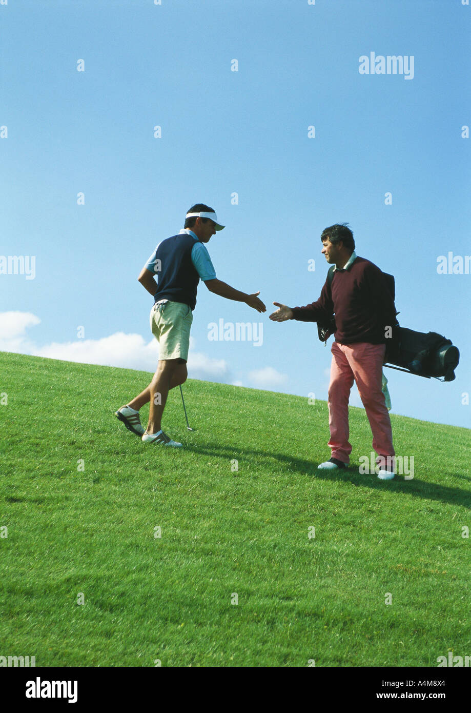 Golfers shaking hands Stock Photo