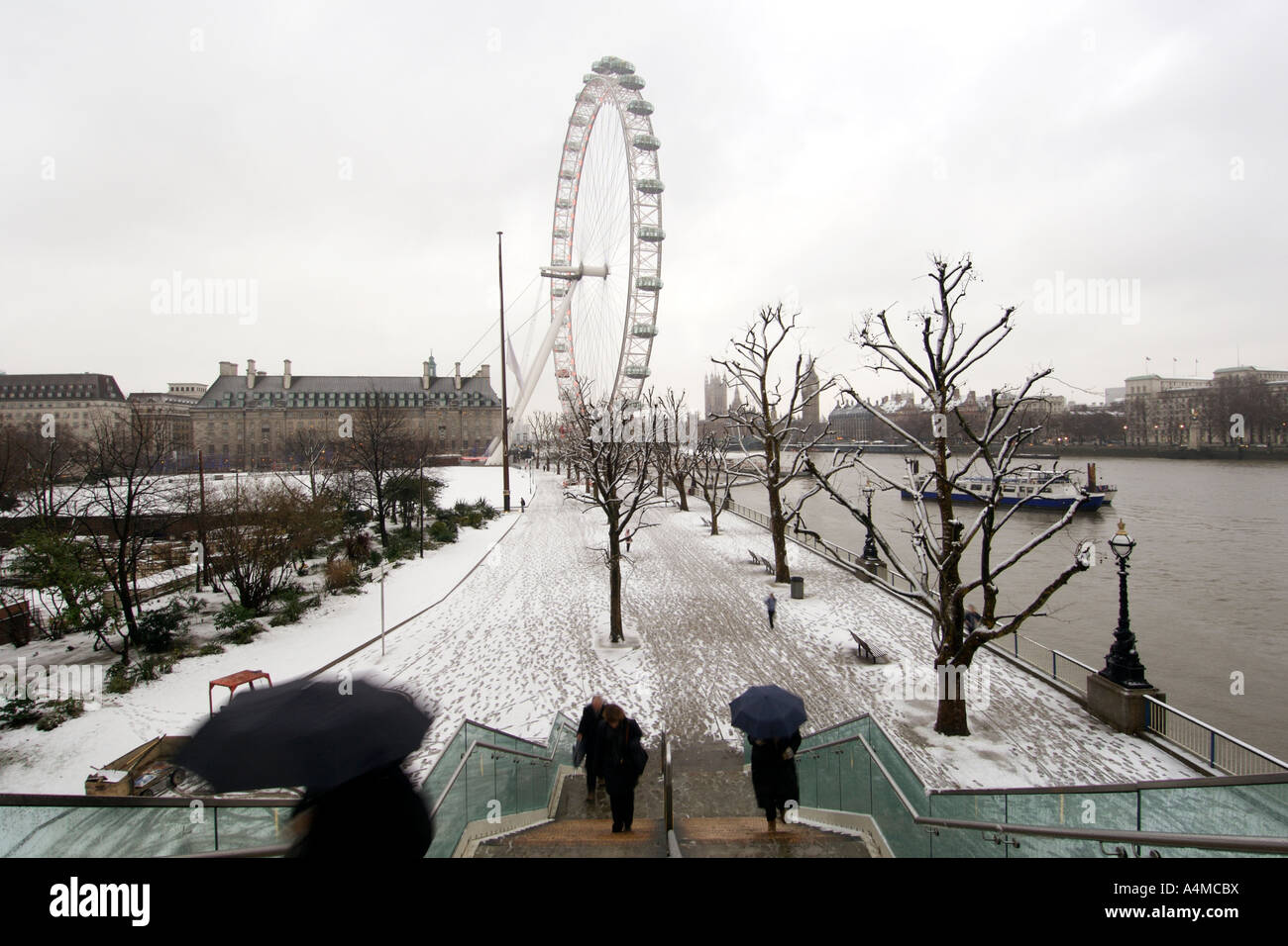 The Thames river embankment in London after a snowfall. Stock Photo