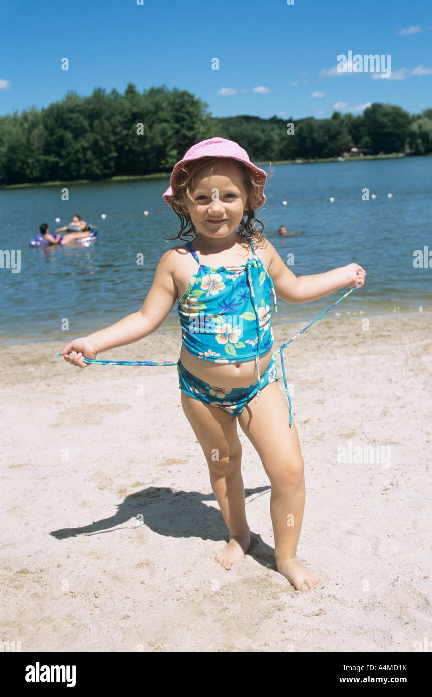 GIRL (4-5 yrs.) ON LAKE SHORE BEACH Stock Photo