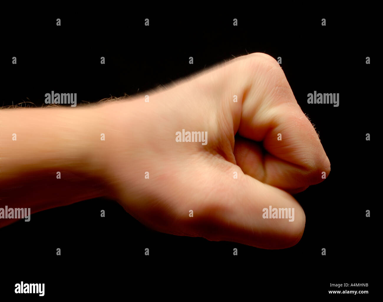 Fist in profile on black background Stock Photo