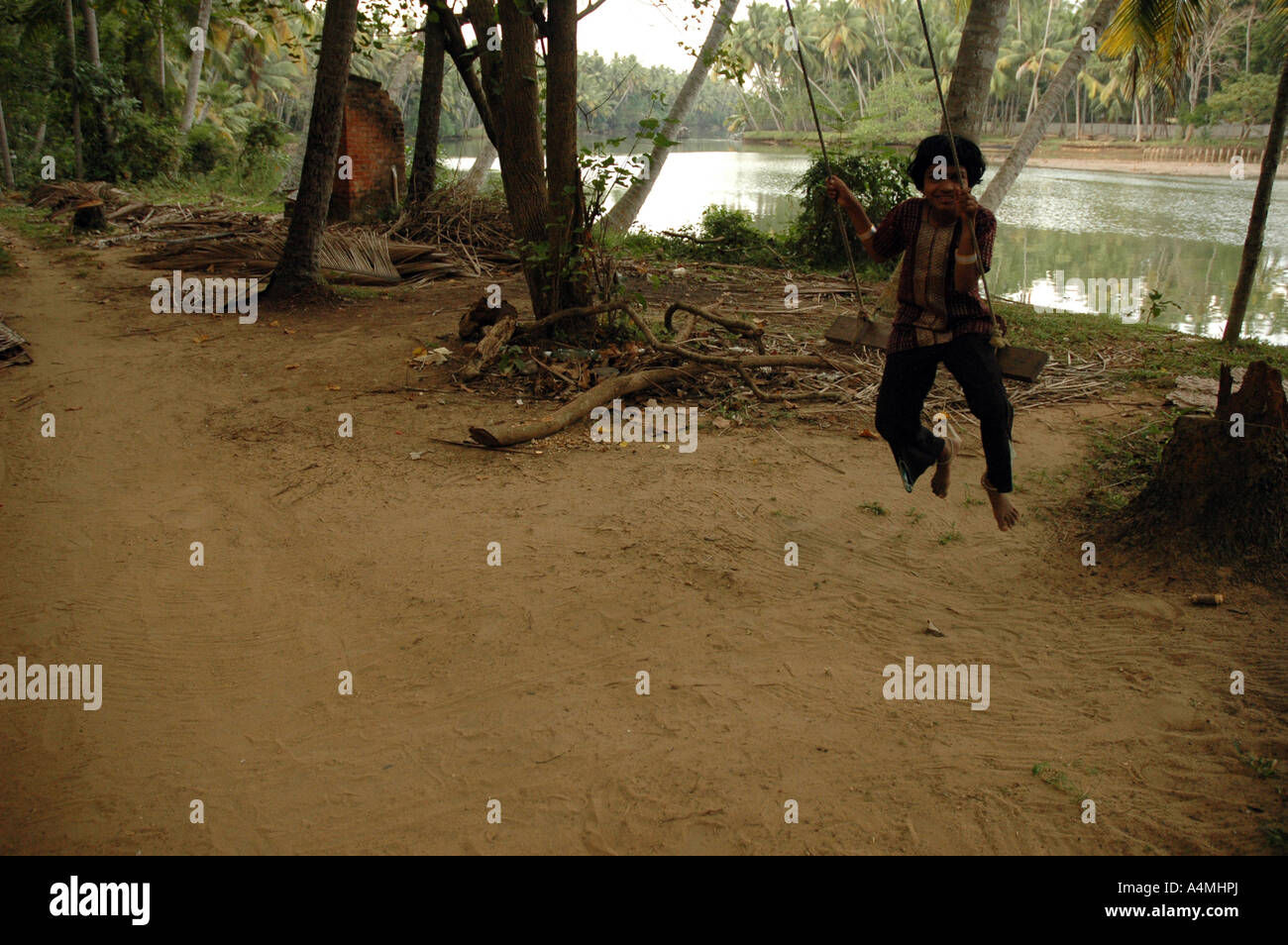 Girl on rope swing in Kerala India Stock Photo Alamy