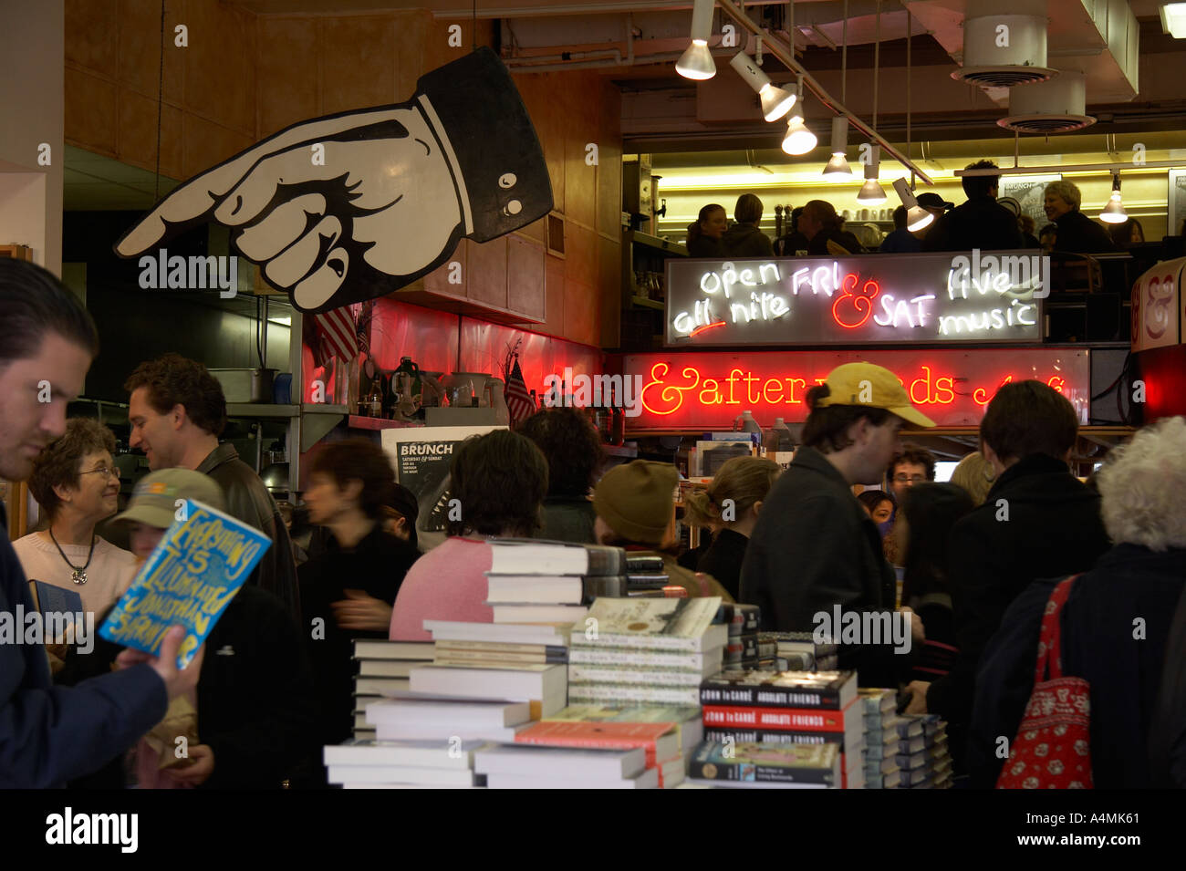 People talking and looking at books while waiting for brunch seating at