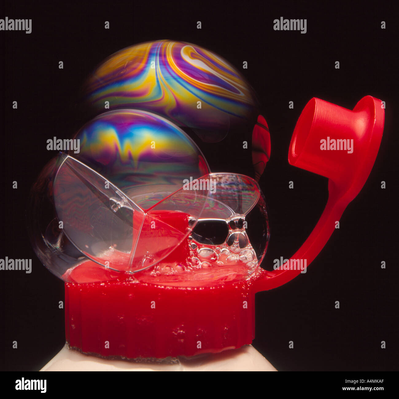 soap bubbles on top of a washingup liquid bottle. Rainbow colors are