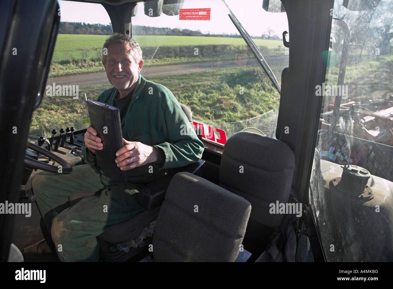 Tractor driver in his cab Stock Photo Alamy