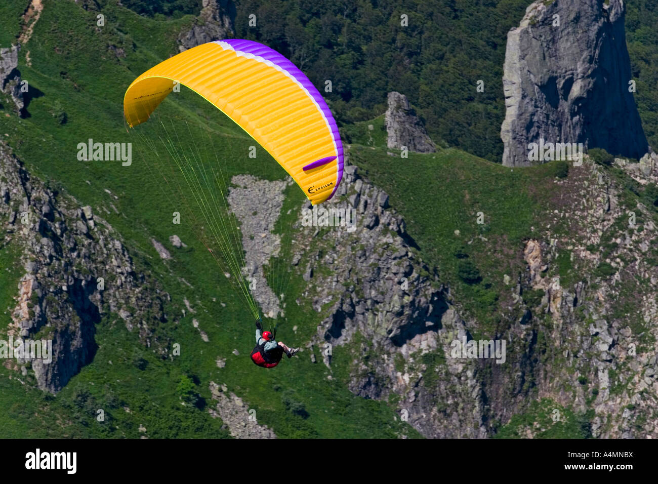 A paraglider over the Sancy Massif (Puy de Dôme - France). Parapentiste en vol dans le massif du Sancy (Puy de Dôme - France). Stock Photo