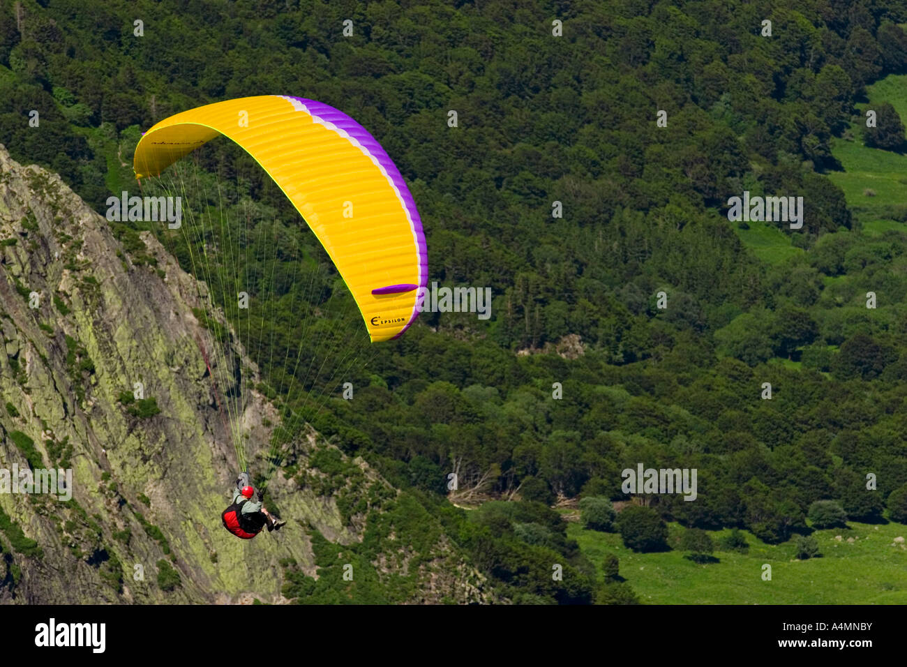 A paraglider over the Sancy Massif (Puy de Dôme - France). Parapentiste en vol dans le massif du Sancy (Puy de Dôme - France). Stock Photo