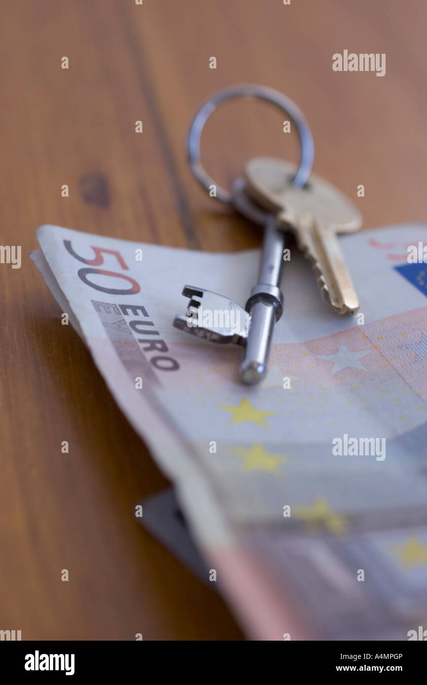 buying property in europe abroad house keys with euro notes euros Stock