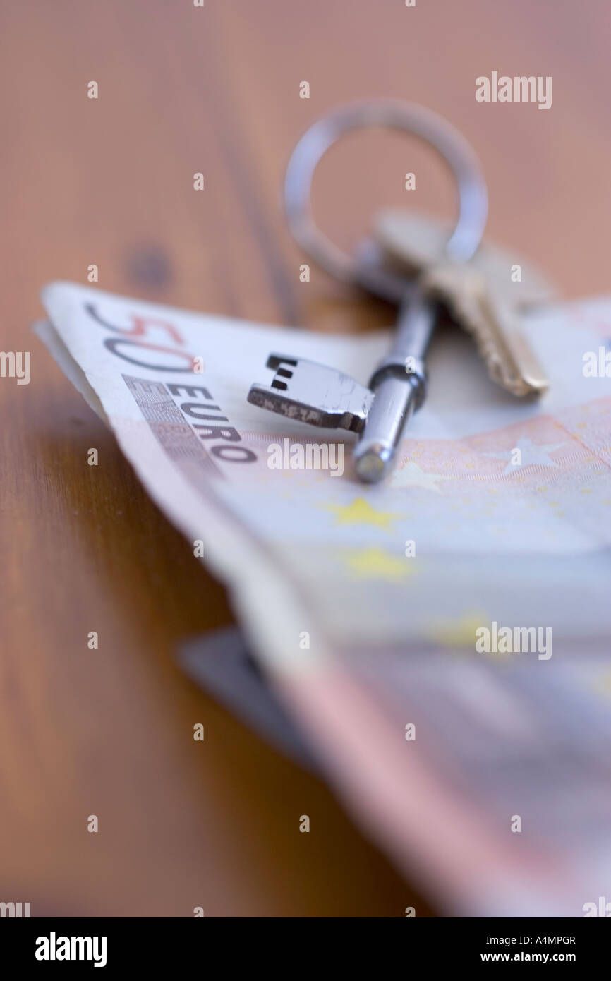 buying property in europe abroad house keys with euro notes euros Stock