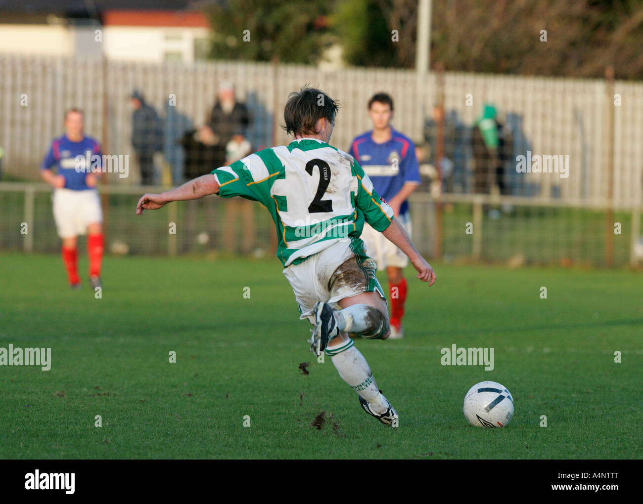 Donegal Celtic player kicks the ball in a free kick against Linfield in the Irish League in Northern Ireland Stock Photo