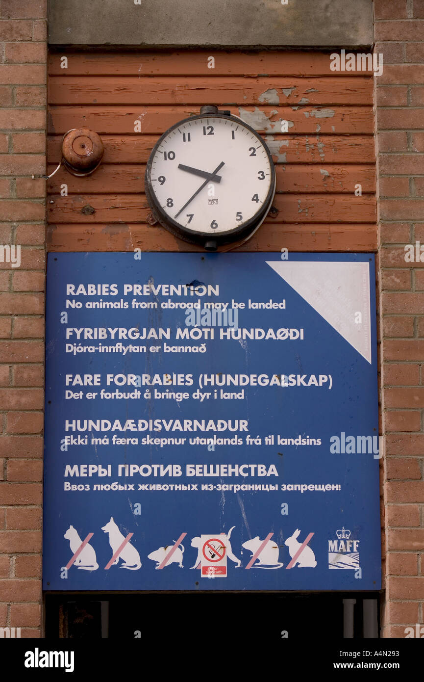 Anti rabies sign and clock at Mallaig harbour Stock Photo - Alamy