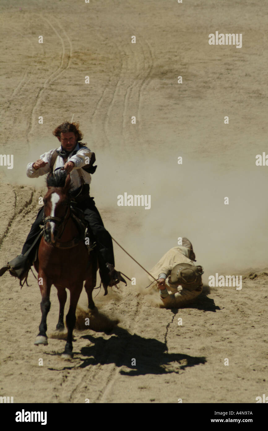 man-being-dragged-behind-a-horse-in-a-western-recreation-A4N97A.jpg