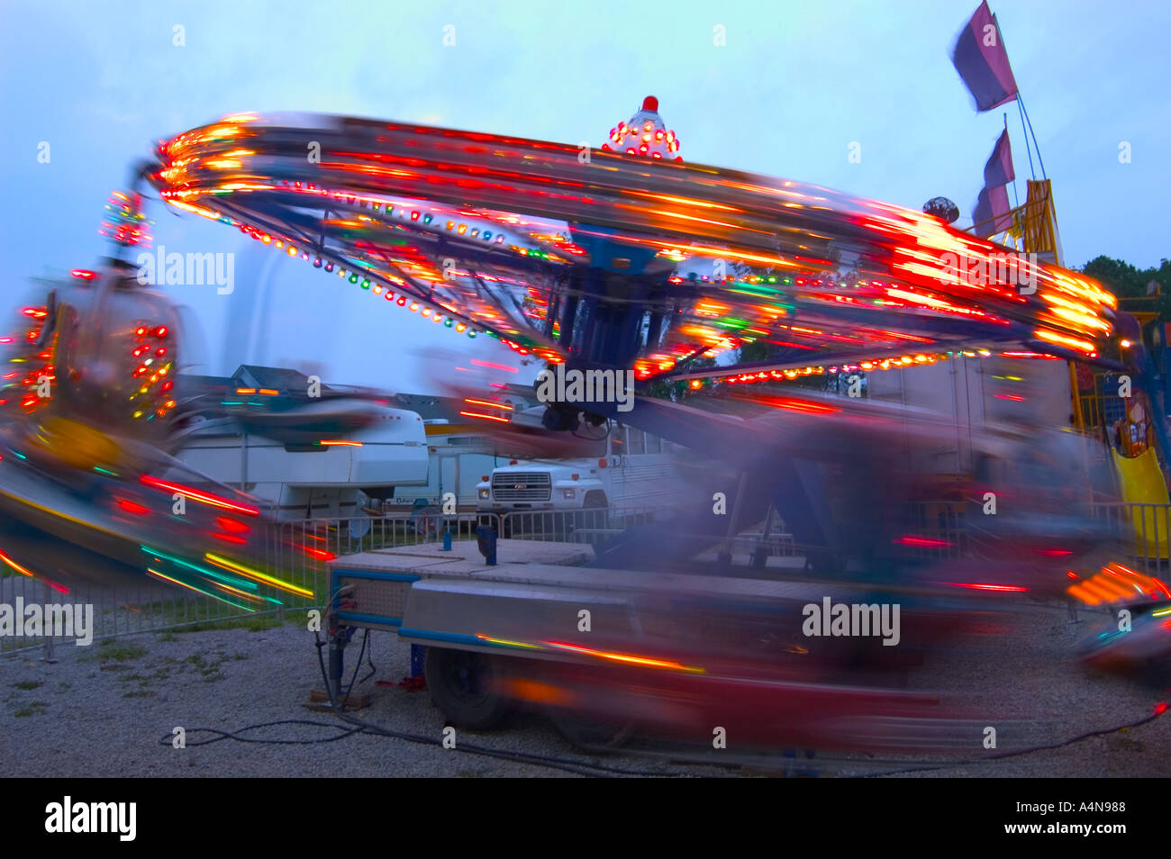 Carmival midway amusement ride in motion Stock Photo - Alamy