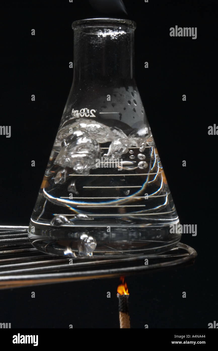 Water boiling in lab flask over bunsen burner Stock Photo Alamy