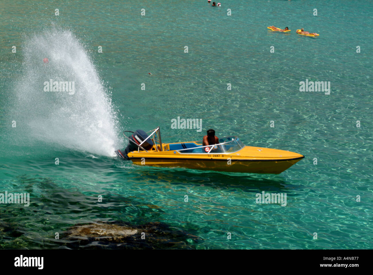 fun sport swimming speed boat spraying water Cyprus holiday Stock Photo