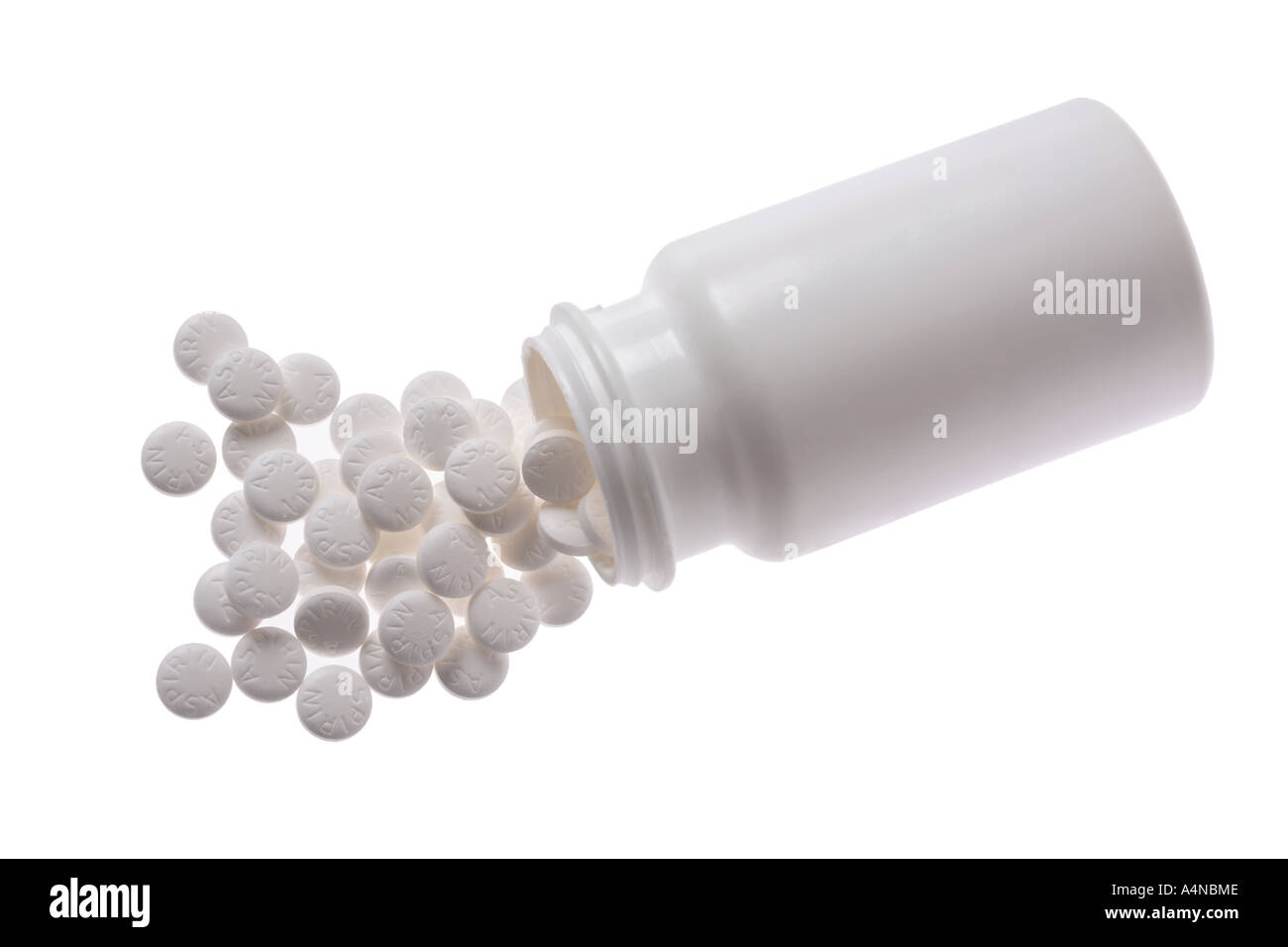 Aspirin bottle with aspirin spilling out Stock Photo