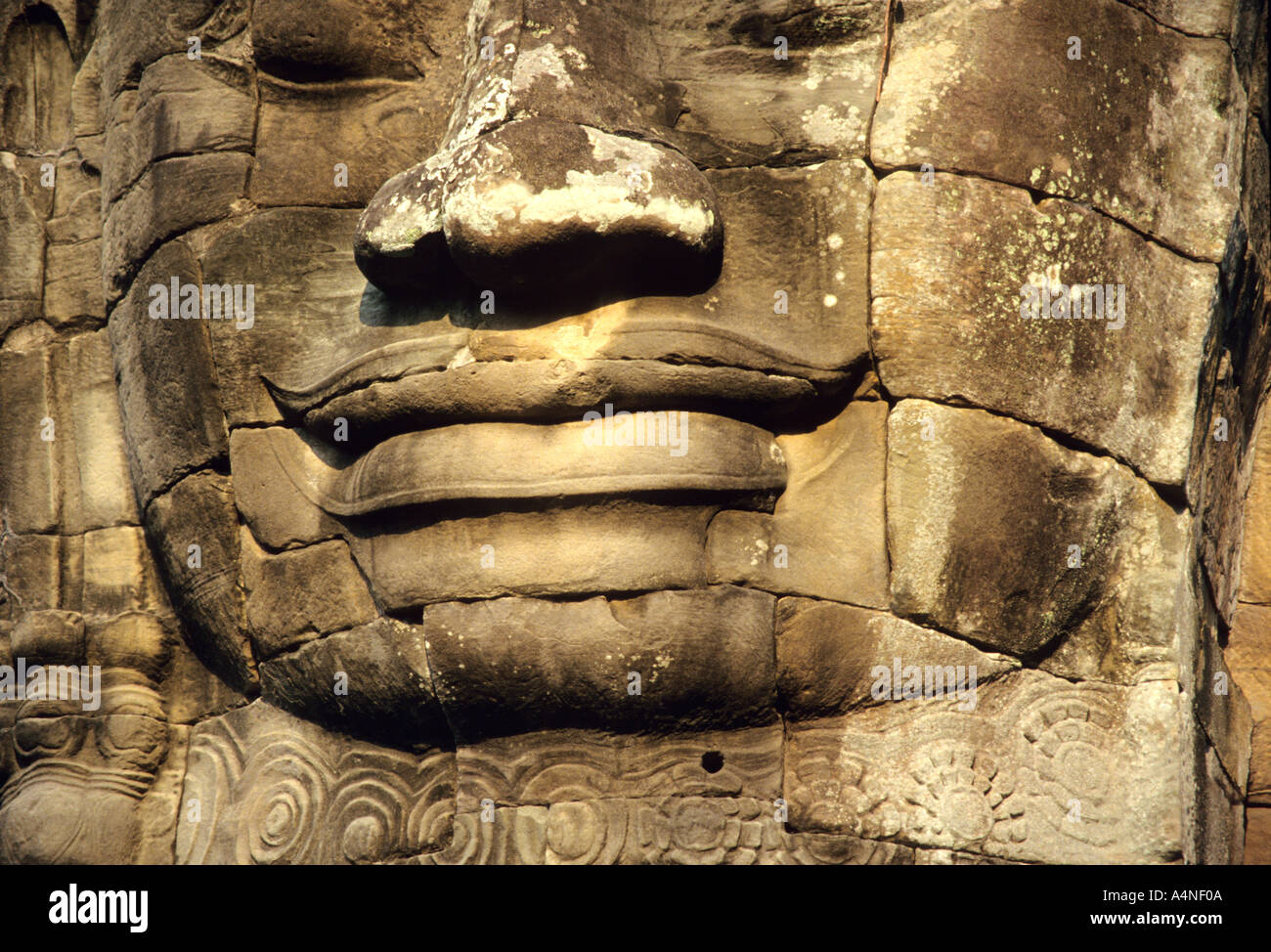 The Smile on the Face of the  huge Buddha head at Angkor Thom in Cambodia Stock Photo