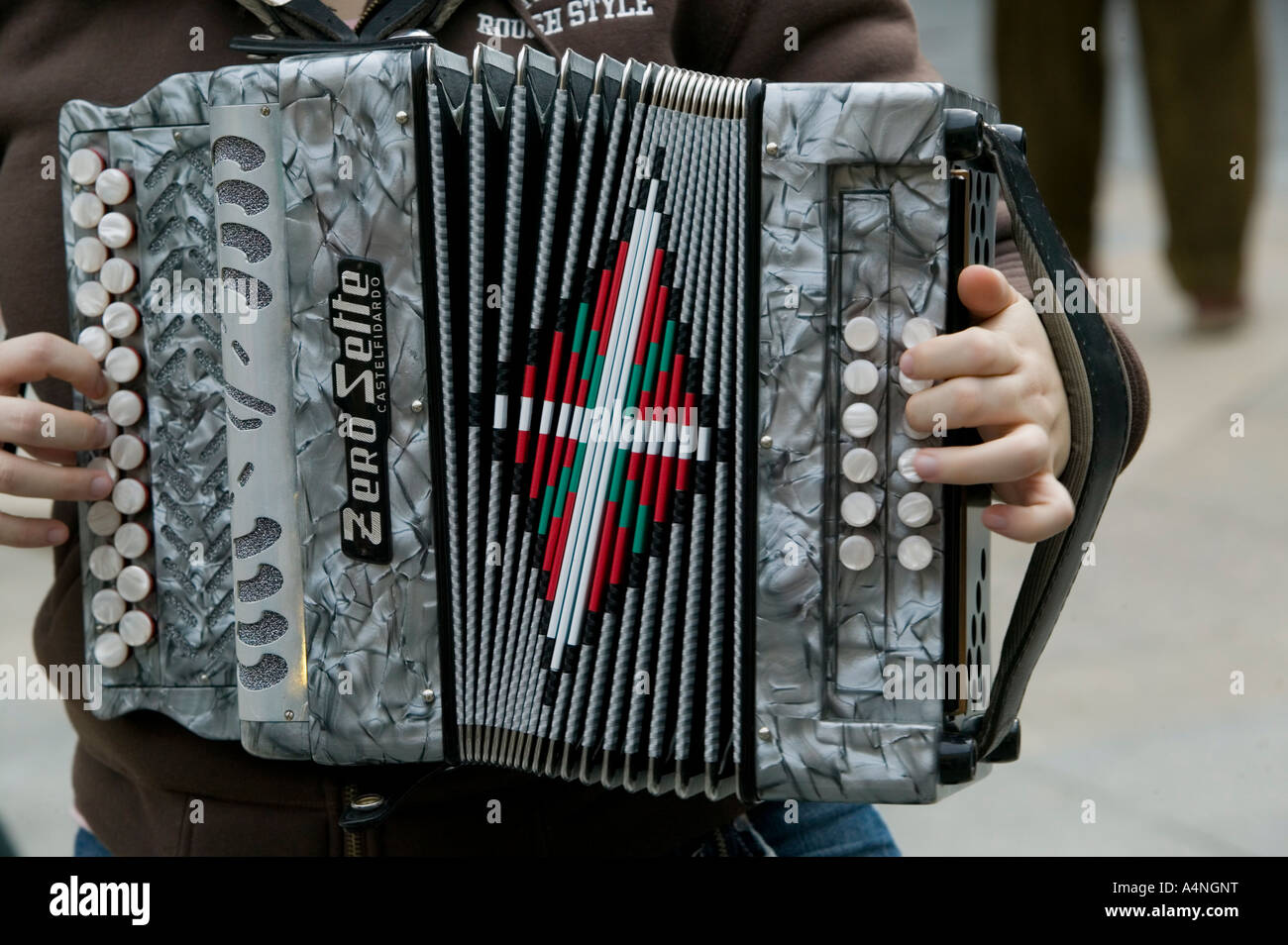 Young Basque man playing traditional Basque accordion with Ikurrina flag, Plaza Nueva, Bilbao Stock Photo