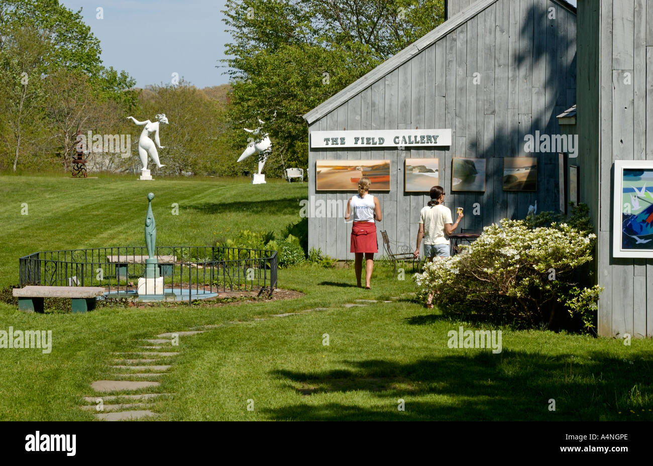 Tom Maley Sculptures in the Field Gallery with 2 Women Looking at Art, West Tisbury, Martha's Vineyard, MA, USA Stock Photo