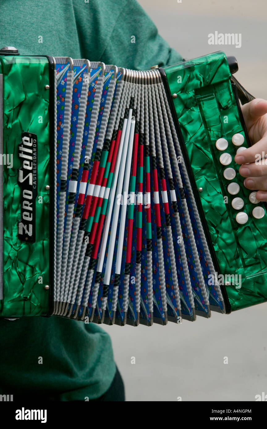Young Basque man playing traditional Basque accordion with Ikurrina flag, Plaza Nueva, Bilbao Stock Photo