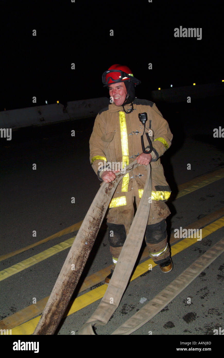 Firefighter pulling a hose hi-res stock photography and images - Alamy