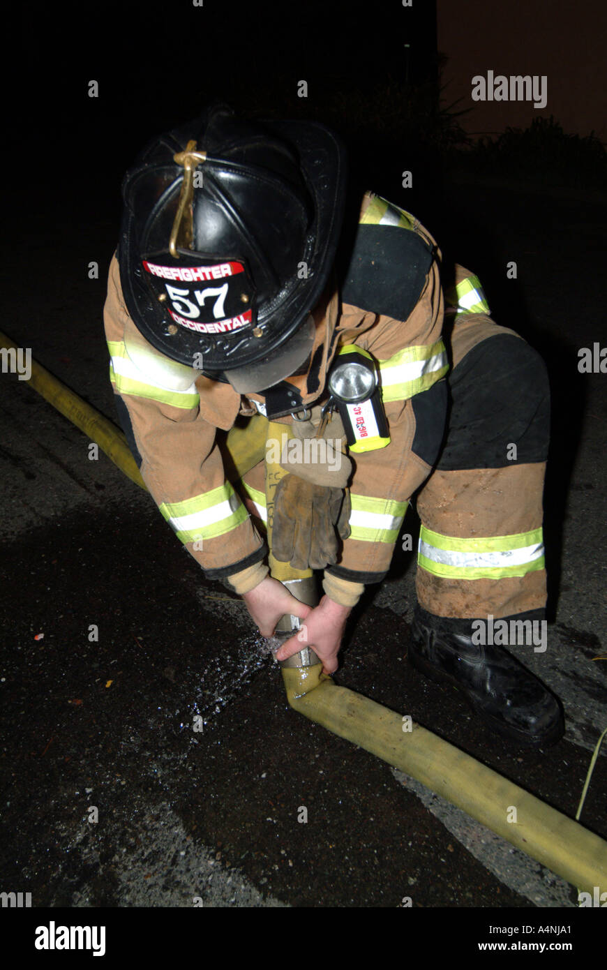 Firefighter pulling a hose hi-res stock photography and images - Alamy