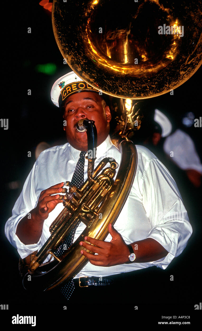 Man plays sousaphone marching with band through French Quarter New Orleans Louisiana USA Stock Photo