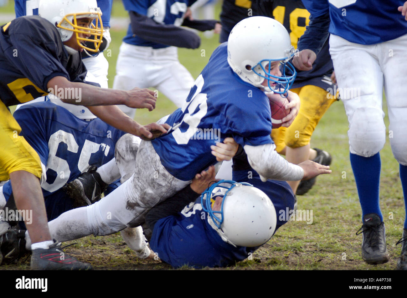 Middle School football action ages 12 to 14 male players Stock Photo