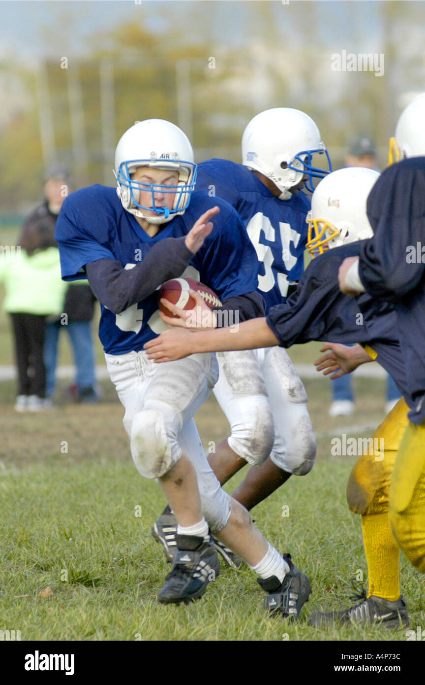 Middle School football action ages 12 to 14 male players Stock Photo