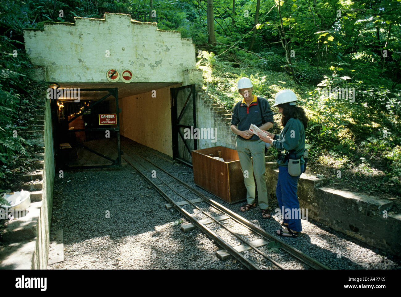 Two tourists waiting to enter the mine complex at Birkhill Fireclay Mine workings Boness Scotland Stock Photo