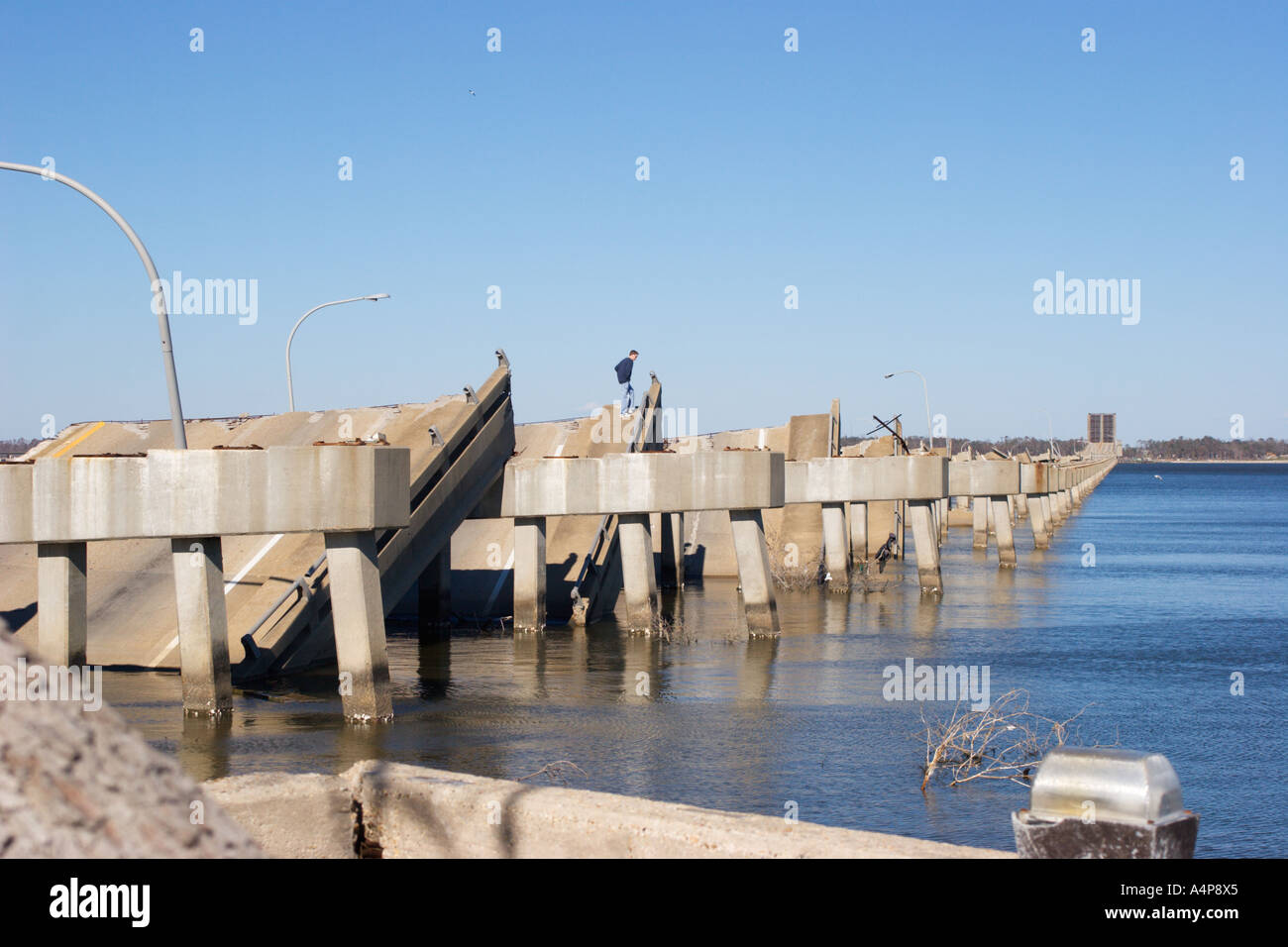 Male teenaged youth standing on remains of Ocean Springs Bridge east of