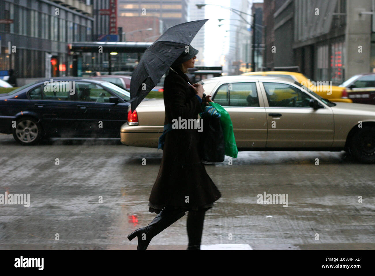 Fashionable woman walking in the rain Stock Photo
