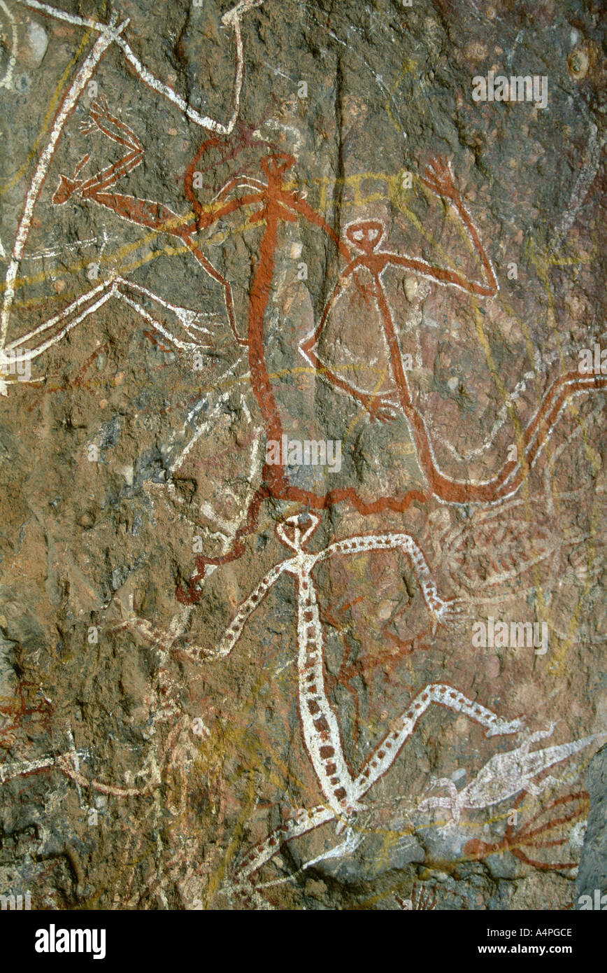 Painting of dancing figures at Nourlangie Rock sacred aboriginal shelter and rock art site in the north east of Kakadu National Stock Photo