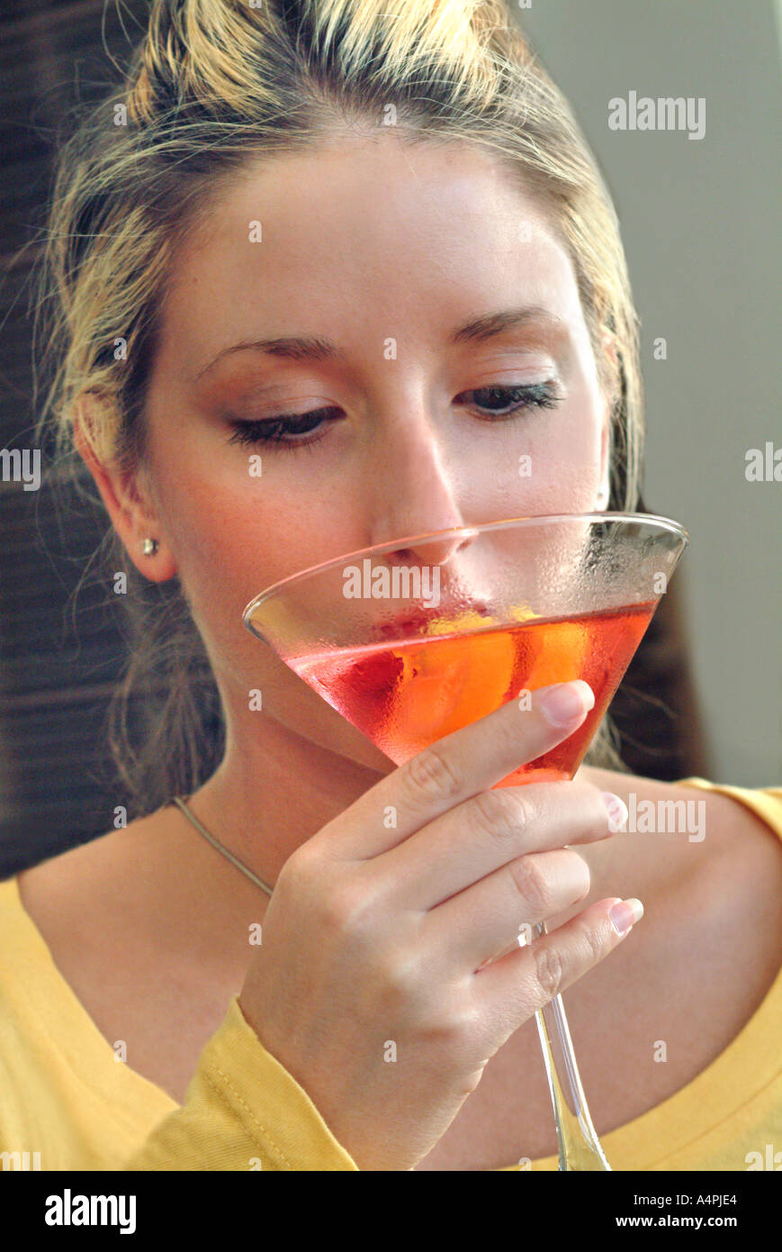 Woman drinking Watermelon martini drink Stock Photo Alamy