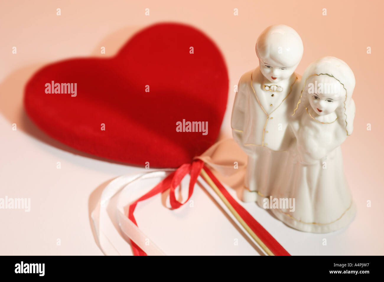 Wedding Couple Figurine and Red Love Heart Stock Photo - Alamy