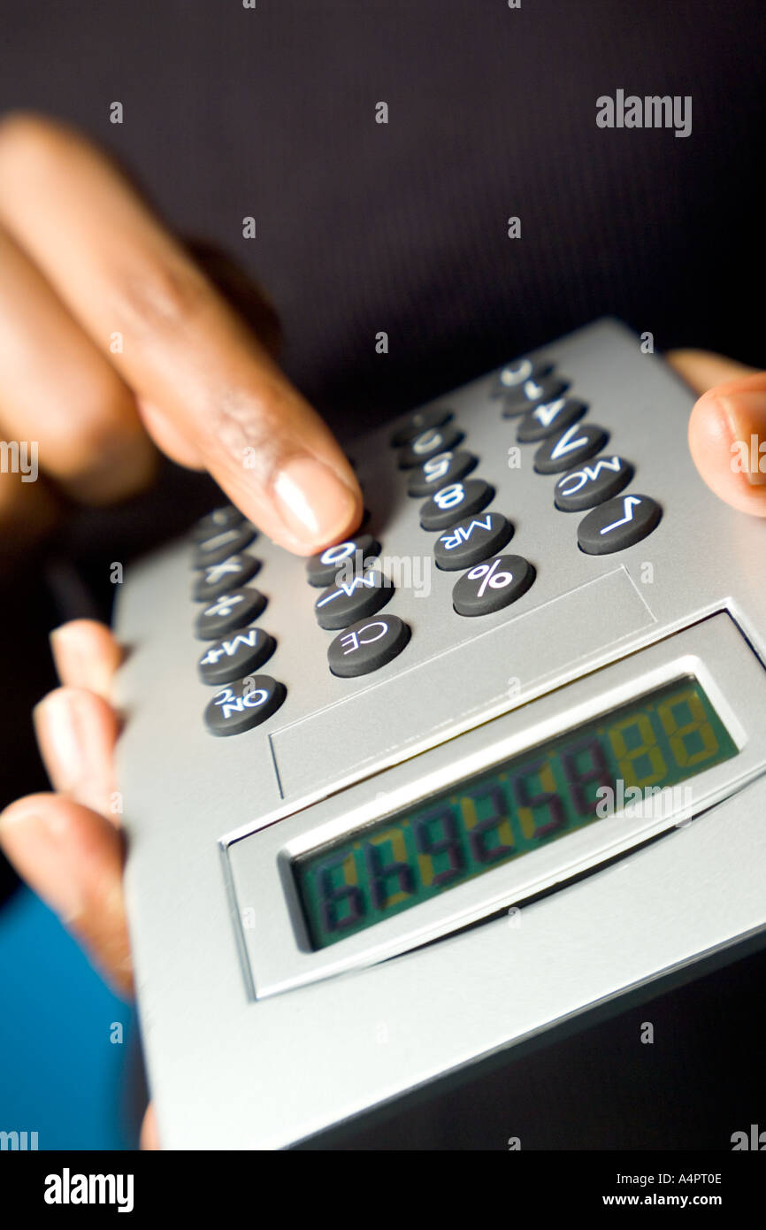 African American Female fingers Hand holding calculator Stock Photo