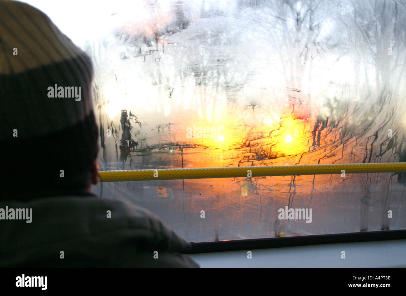 A passenger travelling on the top of a bus during an early winter morning, London, UK. Stock Photo