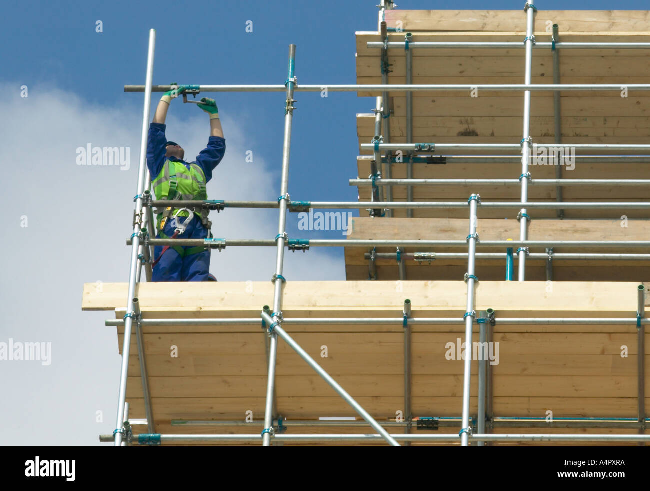 builders erecting scaffolding around an old building Stock Photo Alamy