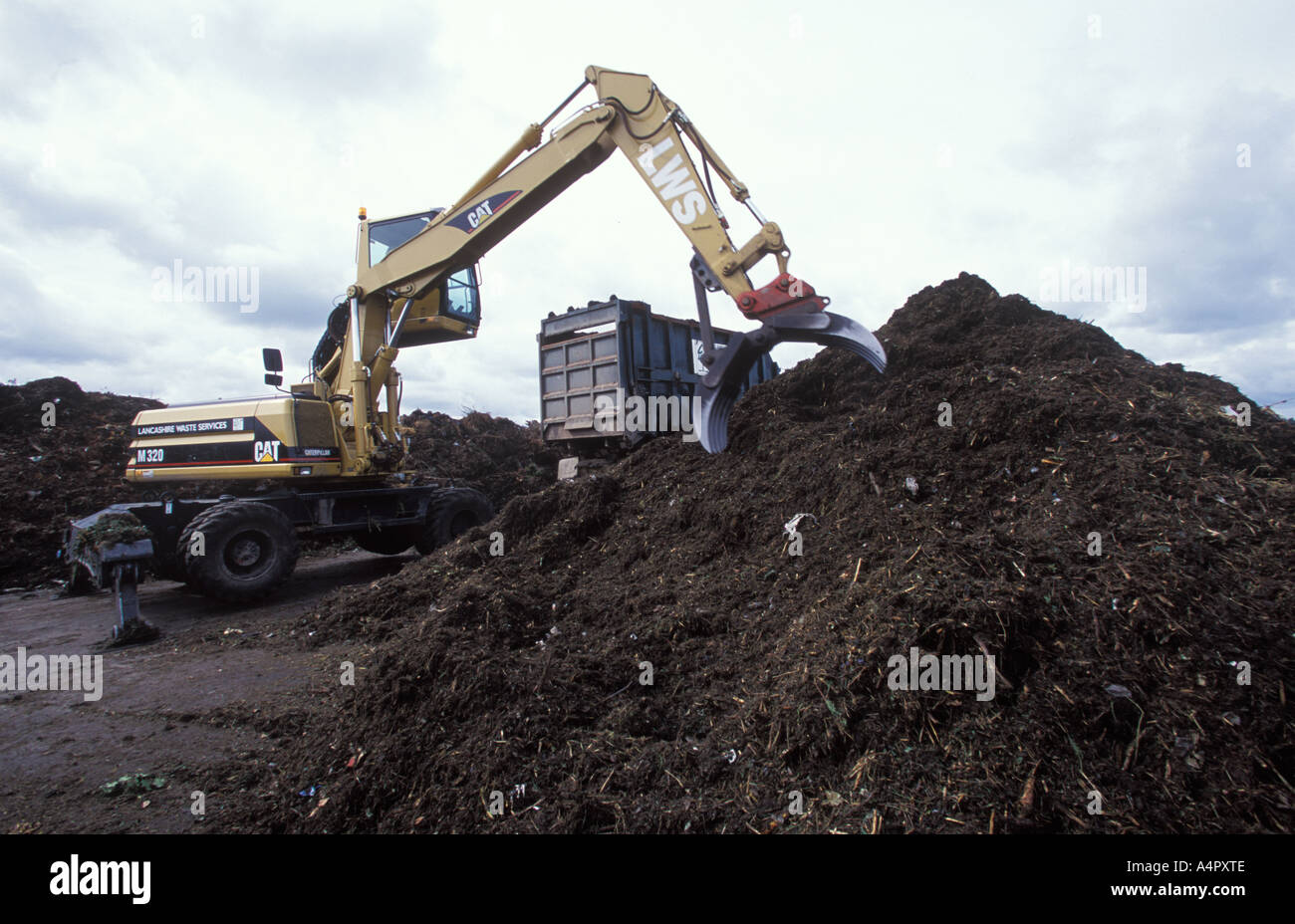 green waste being moved for processing at local tip Stock Photo
