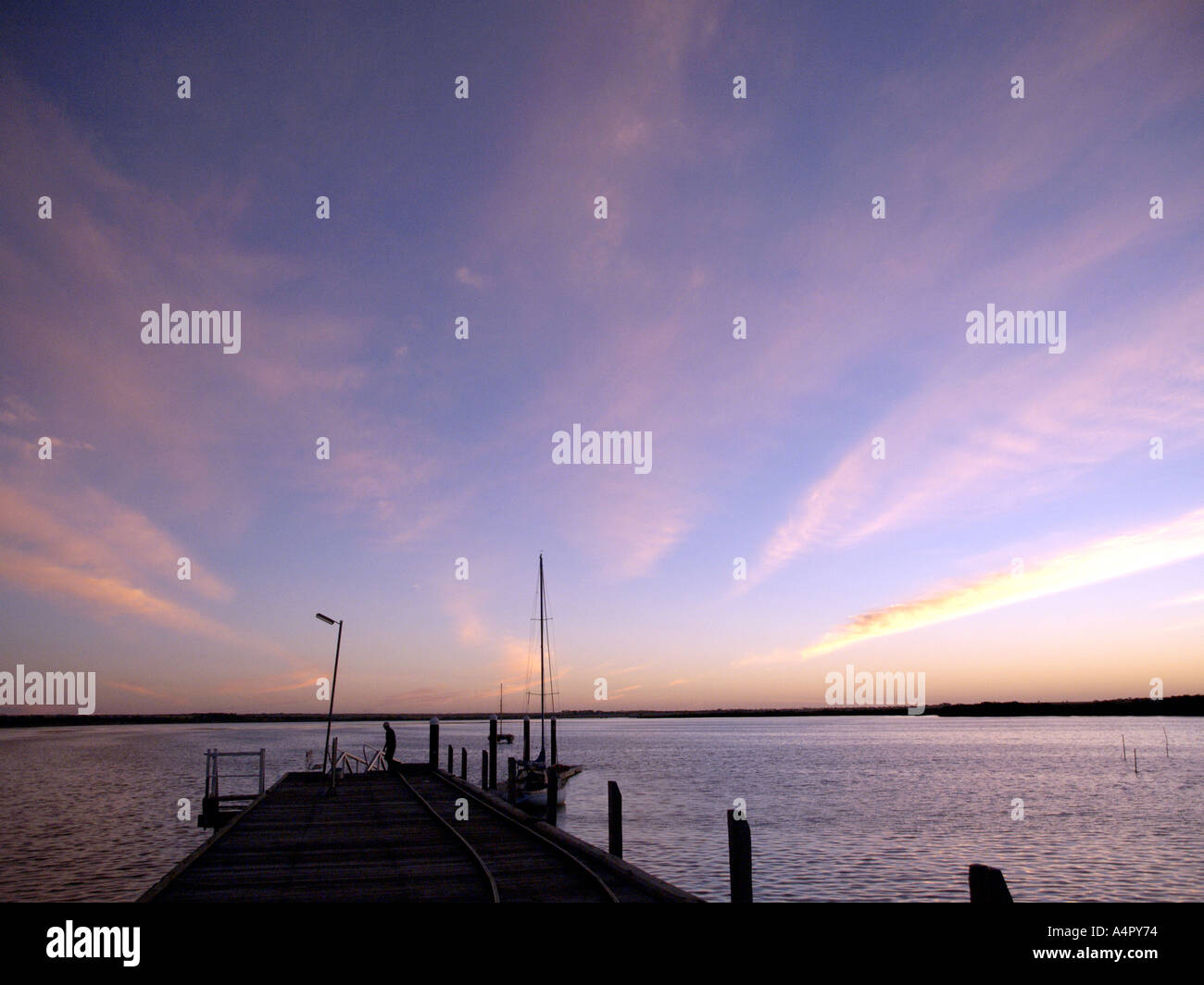 EVENING DUSK LIGHT WITH BOAT ON JETTY PORT BROUGHTON YORKE PENINSULAR SOUTH AUSTRALIA Stock Photo