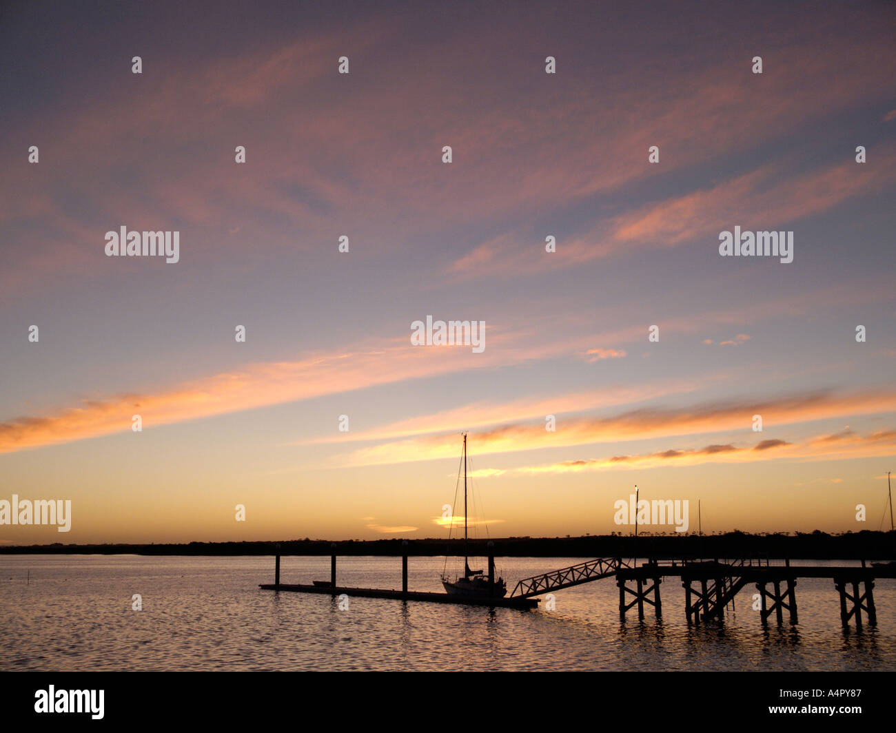 EVENING DUSK LIGHT WITH BOAT ON JETTY PORT BROUGHTON YORKE PENINSULAR SOUTH AUSTRALIA Stock Photo