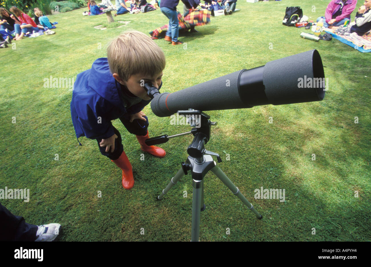 young school boy looking through a bird watchers telescope Stock Photo