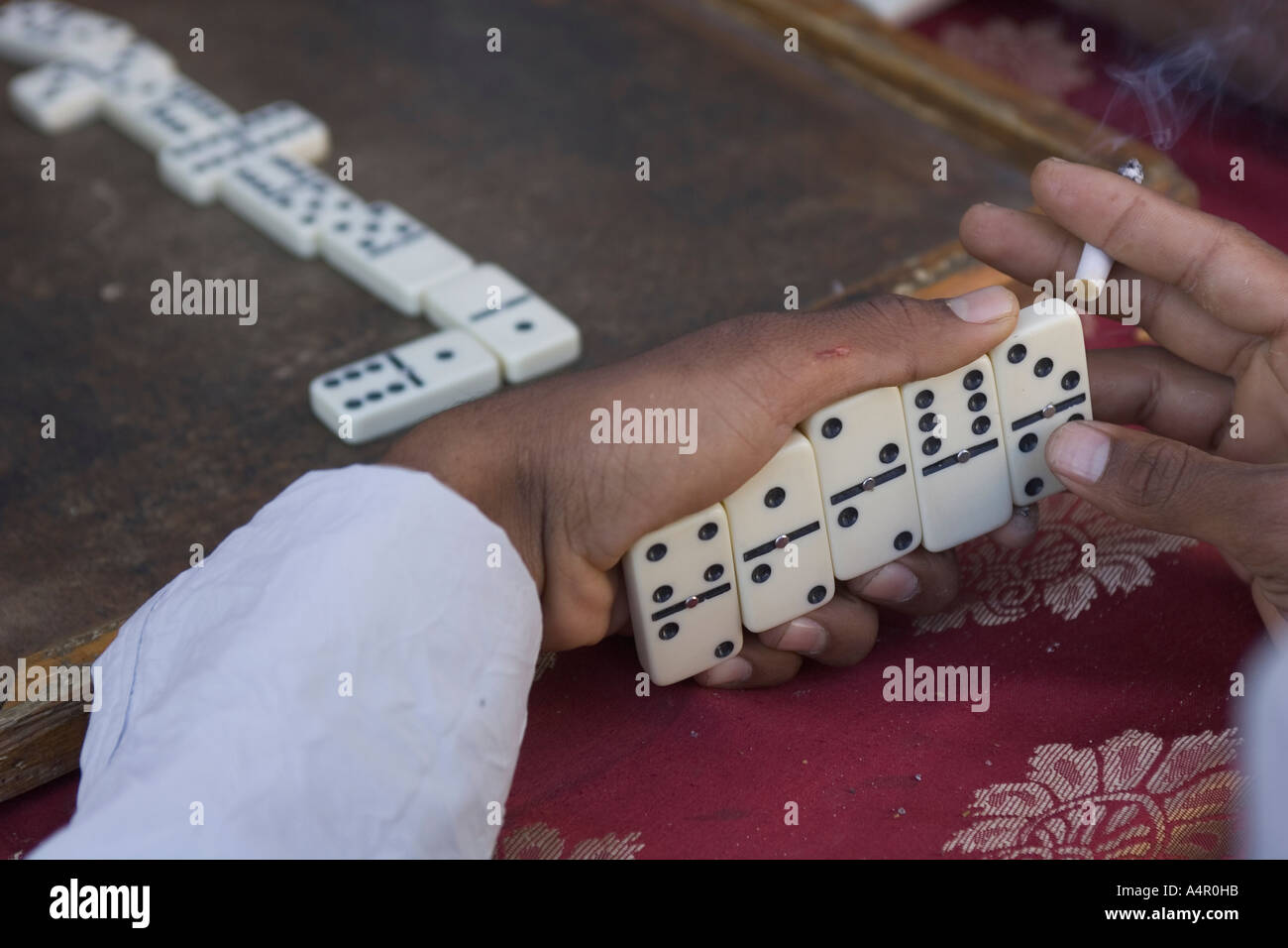 close-up-of-a-person-s-hands-holding-dominos-A4R0HB.jpg