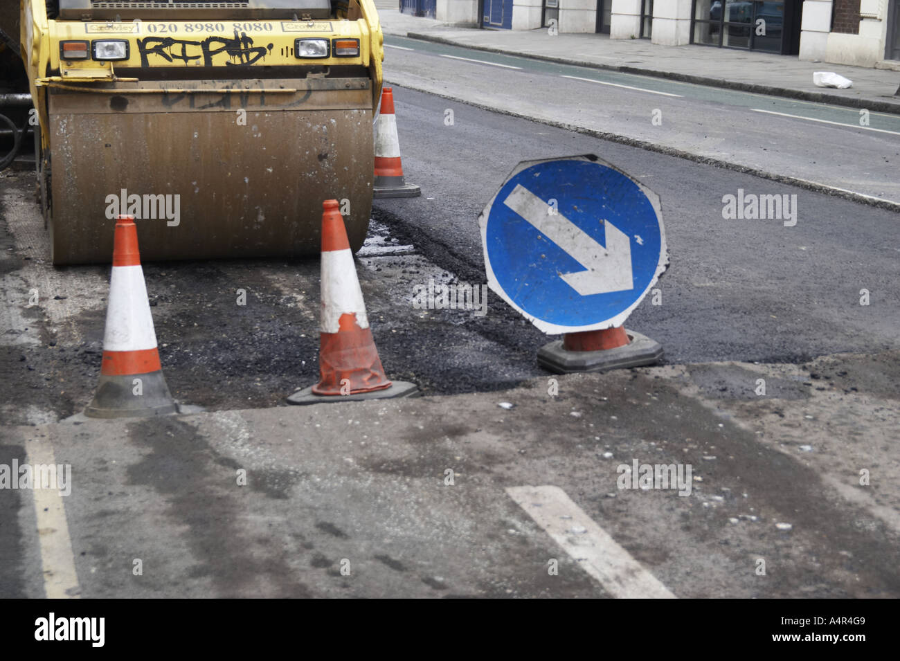 Roadworks road resurfacing in London UK Stock Photo