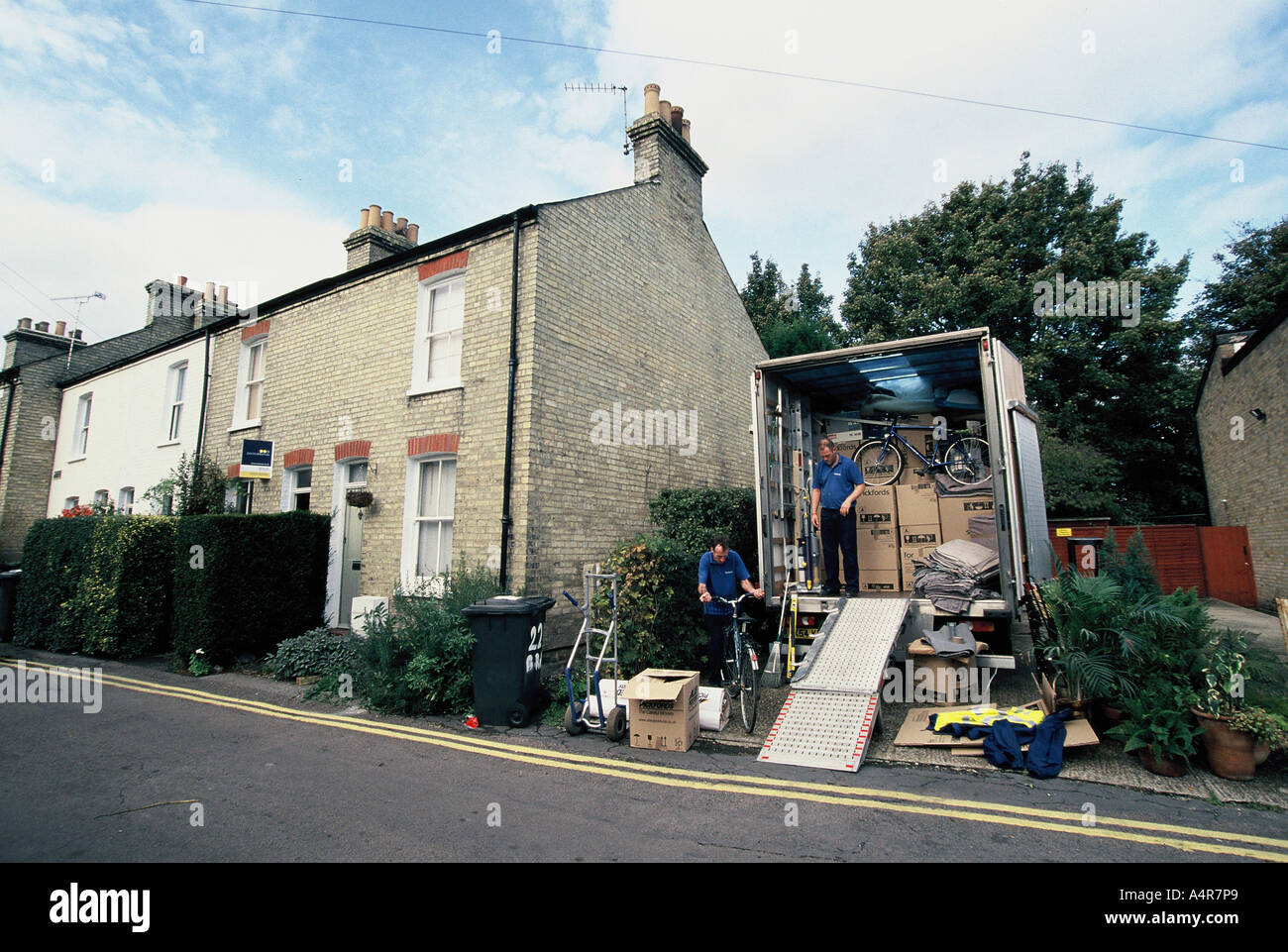 Moving house, removals van loading outside victorian terrace Stock