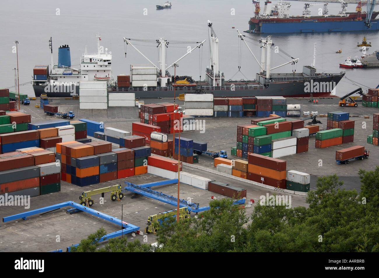 Container ship and dockside full of shipping containers in a busy