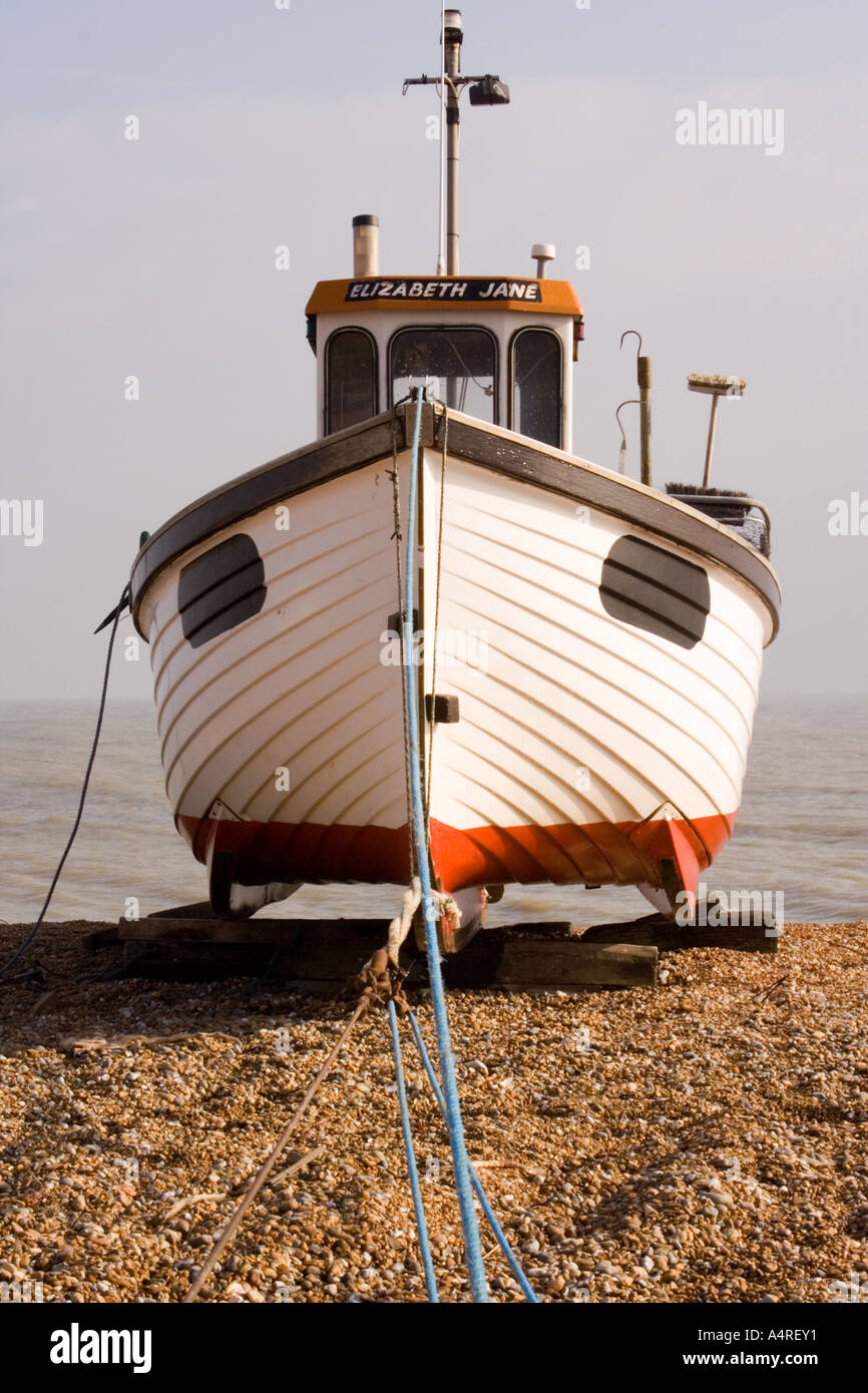 Fishing boat with reinforced keels winched up onto the shingle beach at