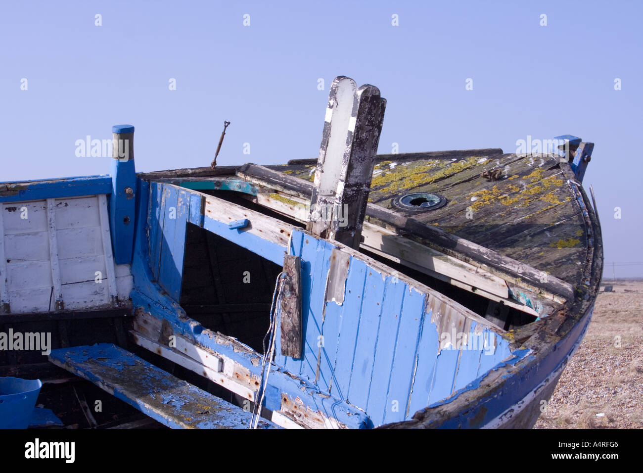 Bows of an abandoned fishing boat sat decaying on the shingle beach at ...